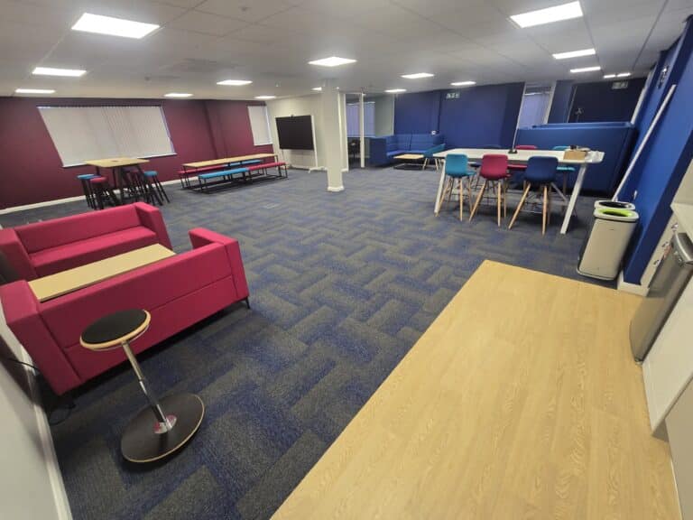 Diversity Groove Jaxx at CIBT college with blue carpet tiles in classroom with blue walls.